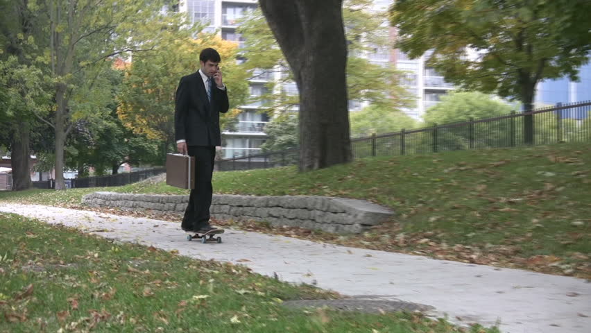 Skateboard businessman. A man in a suit on his way to work via skateboard. Rise of the Y Generation! (also known as the net, next, and/or Millennial Generation). 