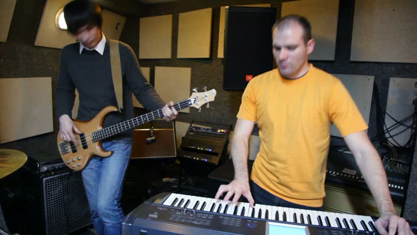 guitarist and keyboard player playing in studio 