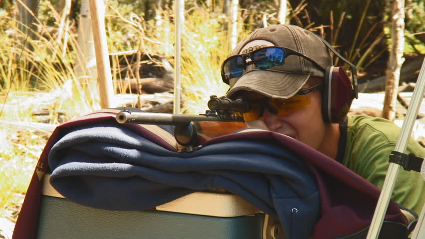 young gunman shoots three shots from vintage .22 caliber rifle