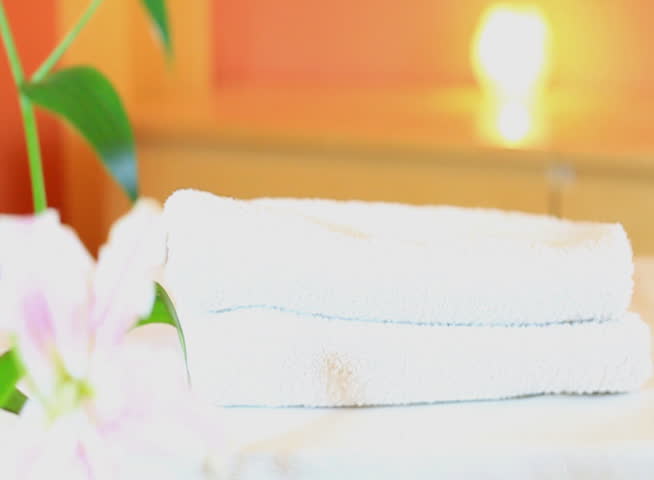 SPA scenery with two lilies falling on white towels, 60 FPS