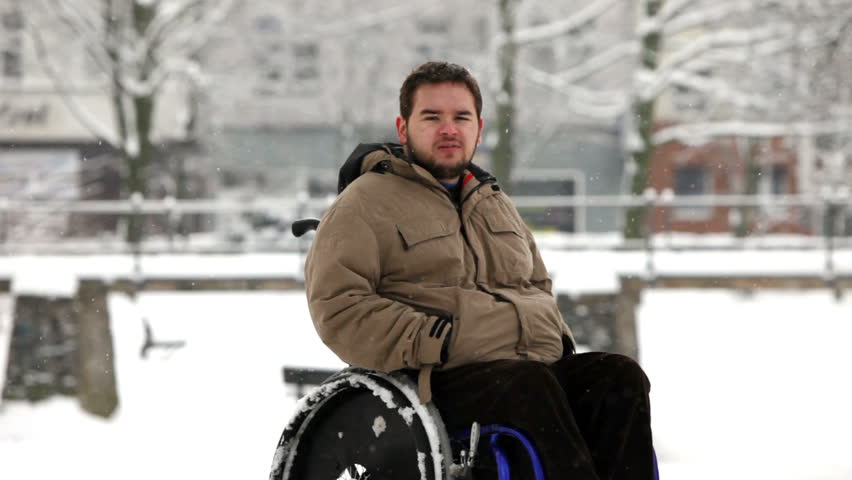 disabled young man in wheelchair at the park 