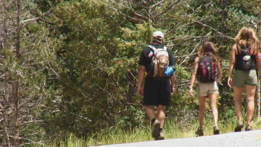 Hikers descend mountain road