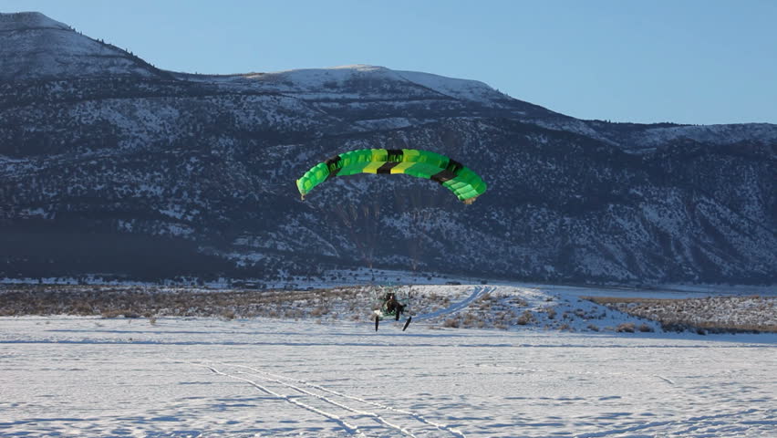 MORONI, UT- CIRCA JAN 2010: Steve Pelton of Moroni lands in Powered parachute circa Jan 2010 in Moroni, Utah, USA.Powered parachute landing past friends on ice.