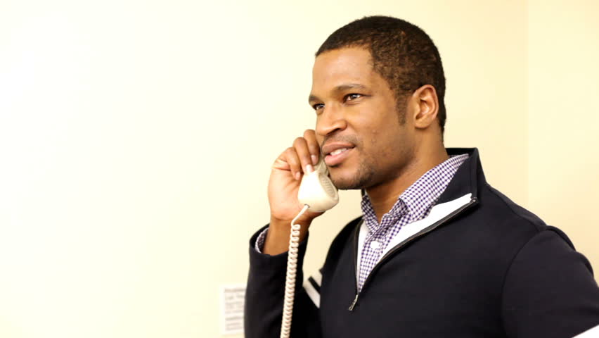 Man on Telephone Smiles at you