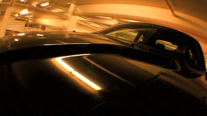 Point-of-view tracking shot of modern metallic finish motor vehicle