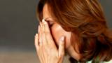 Mature lady holding her forehead suffering from headache