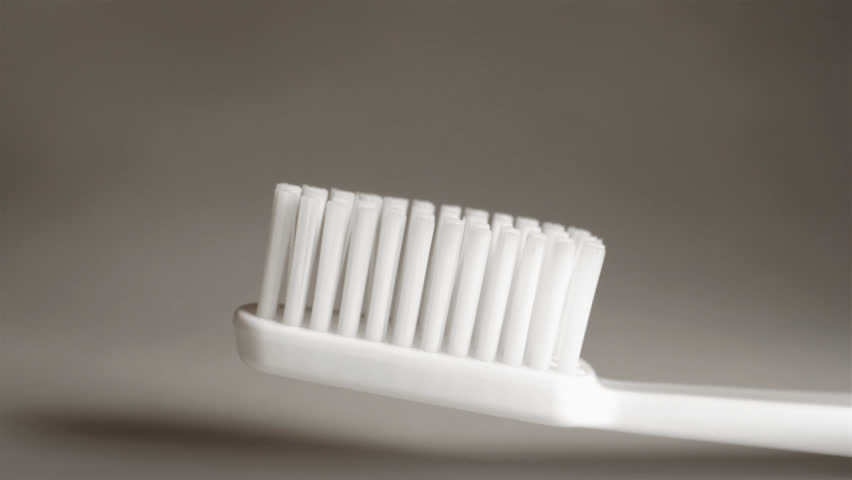 squeezing toothpaste on a brush