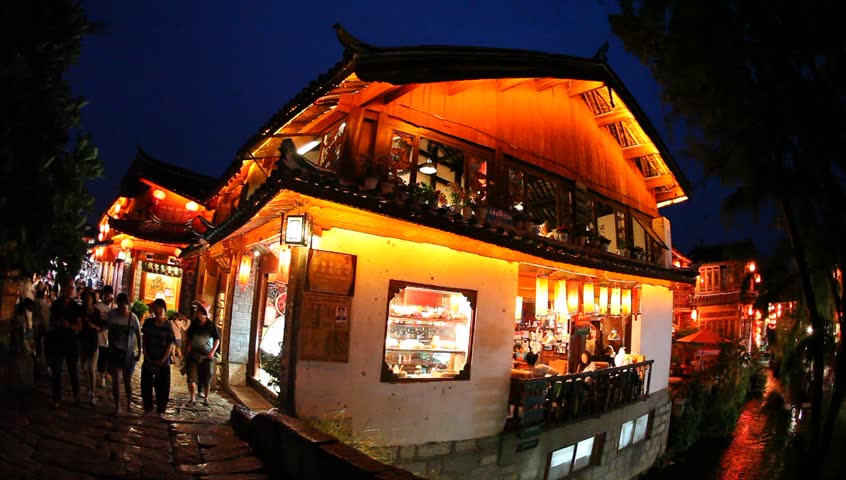 Lijiang, China - August 20: In the peak of the season, Chinese and world travelers enjoy  old town Lijiang including old architecture, restaurants and the local river in Yunnan, August 20, 2009