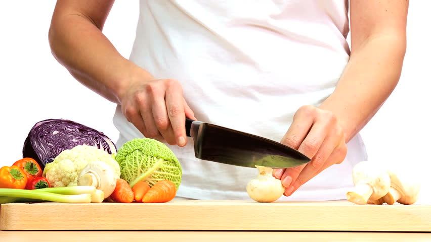 Healthy fresh vegetables being chopped to provide ingredients for modern lifestyle food