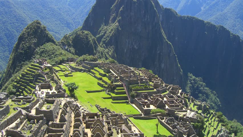Time Lapse Movie over ruins of Machu Picchu in Peru with some tourists walking by