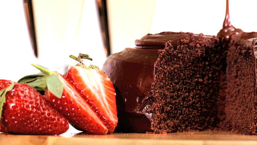 Indulgent sticky chocolate cake served with fresh strawberries & sparkling white wine