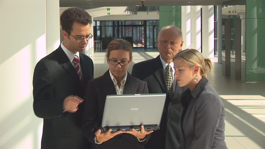 businesspeople looking into notebook