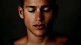 Closeup of confident young man looking against grunge background