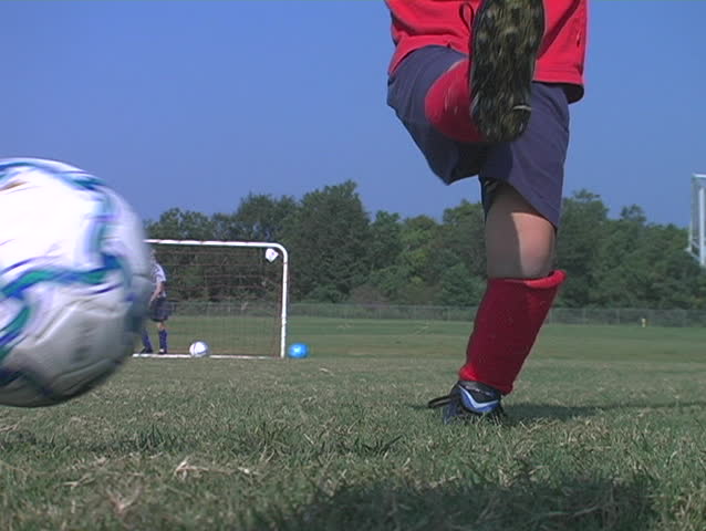 Little boy kicks a soccer ball - slow motion