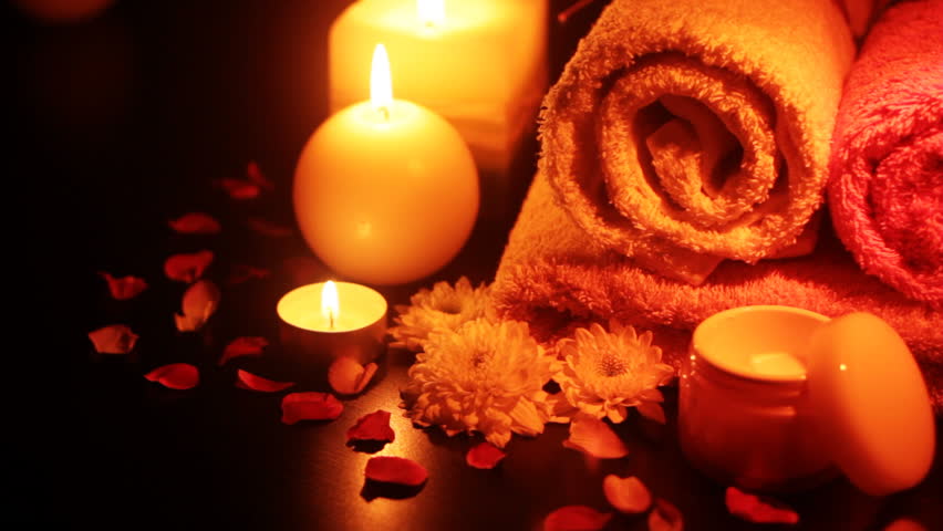 Spa accessories (moisturizer, candles, towels) at therapy center 