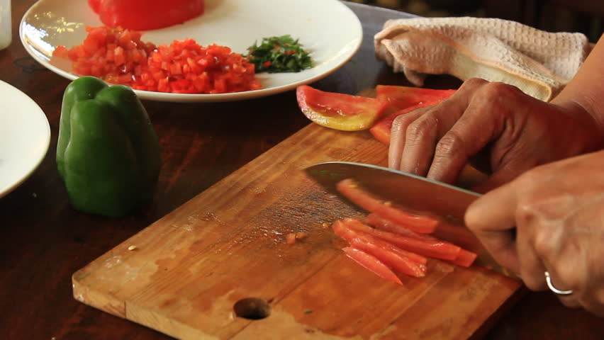 A chef slicing tomato
