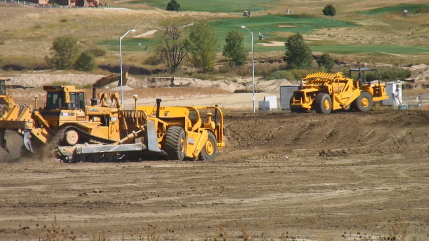 Heavy construction equipment works to excavate soil - HD, audio