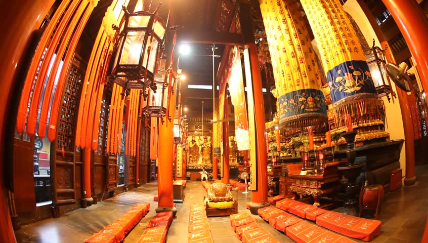 SHANGHAI, CHINA, - Buddhist visitors pray and light incense to practice their belief at Jade Buddha Temple (Yufo Si) - Shanghai, China, July 08, 2009