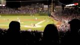 Crowd cheers at baseball game, silhouette