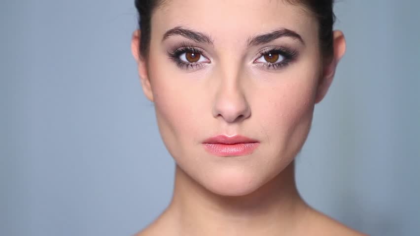 Beautiful young woman applaying cosmetics 