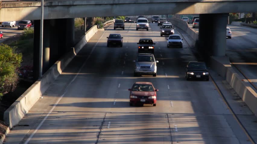 Traffic 05 Time Lapse: Rush hour traffic driving under a freeway overpass on the Santa Monica Freeway in Los Angeles.