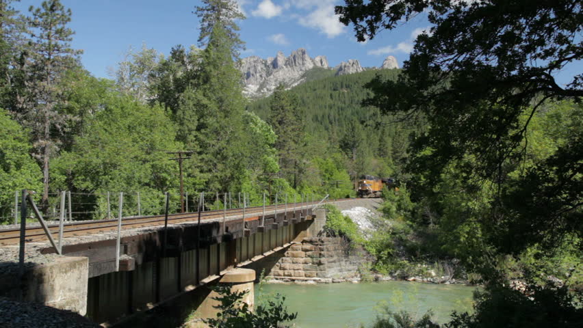 CASTELLA, CA - JUNE 20: A slow-moving Union Pacific freight train crosses over a creek underneath the Castle Crags in Castella, California, June 20, 2010.