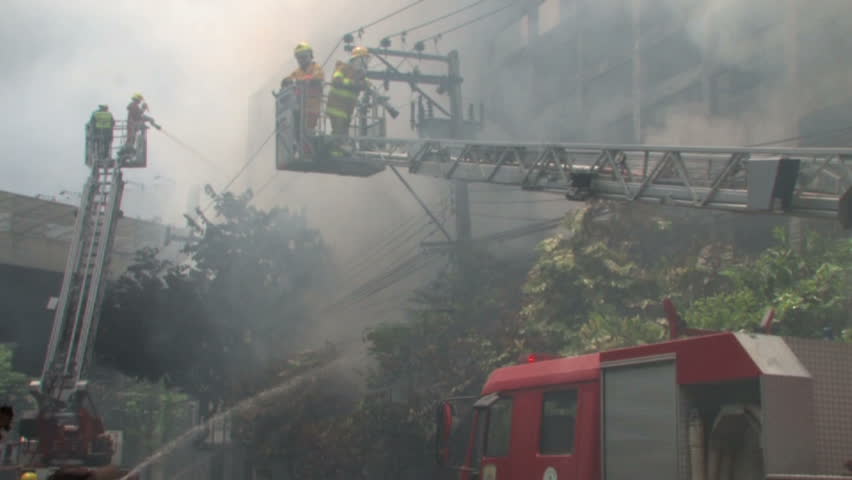 BANGKOK, THAILAND - April 19, 2010: Firemen battle blazes across the city after protesters set more than 40 buildings on fire during a government crackdown 