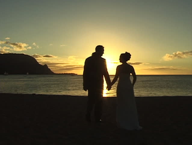  Silhouette of Man & Woman walking into sunset