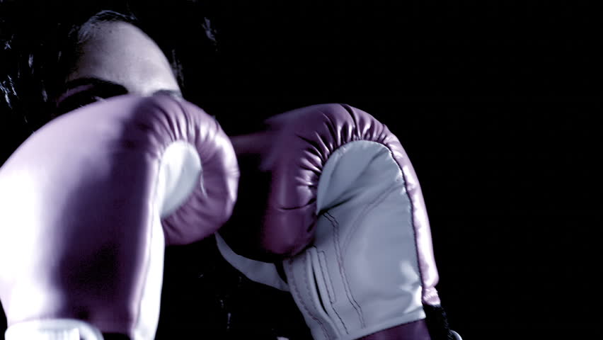 A Latino woman boxes.