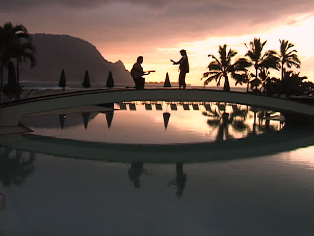 Hula dancer with guitar player on bridge