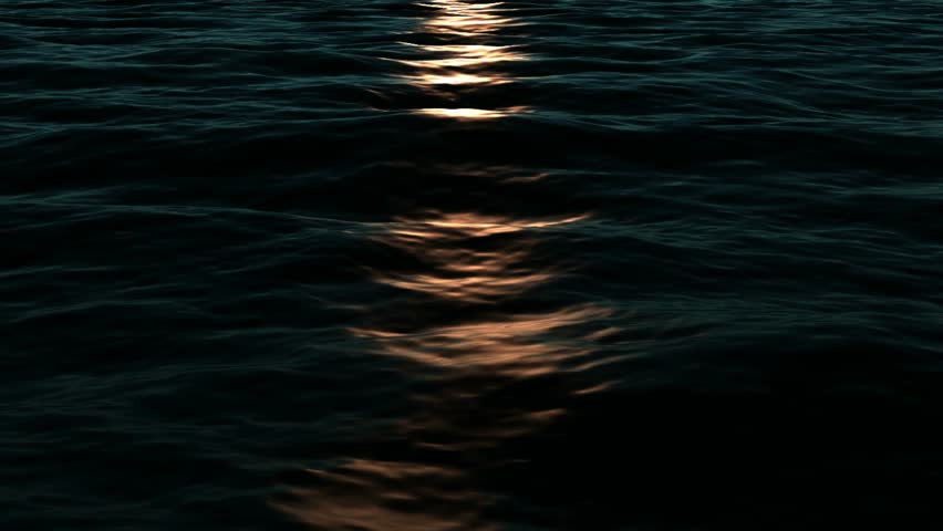 Animated Simulation of golden Light Falling on the surface of the sea at night. This could be used to show either moonlight on the sea or a ship coming or even a lighthouse