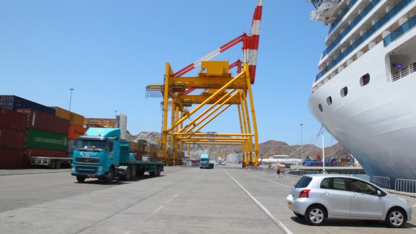 trucks moving to camera in seaport with ship