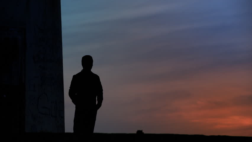 Thoughtful man standing towards sunset/sunrise. Full HD, 1080p, 1920x1080.