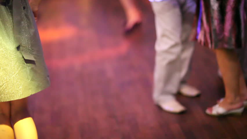 People dancing on disco. Legs closeup view. 