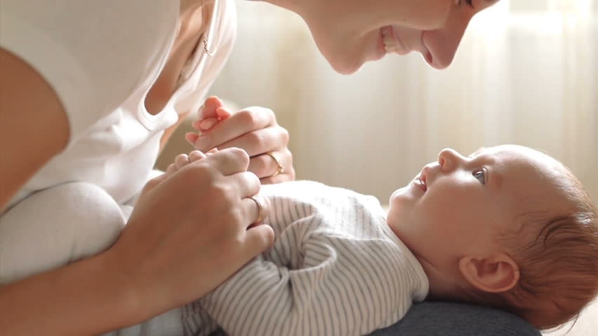 Mother kissing her child (slow motion)