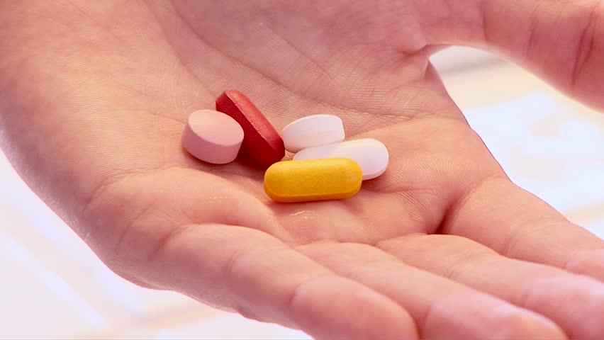 Woman with pills in her hand