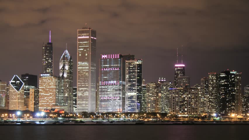 Time lapse Chicago Skyline at night. All trademarks are blurred.  