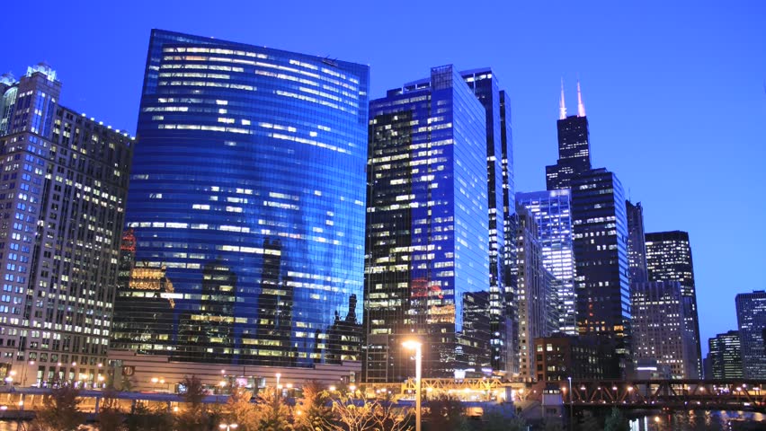 Time lapse Chicago Skyline at twilight. All trademarks are blurred.  