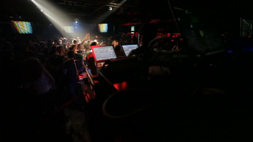 wide view of vj and light mixer on dance-floor