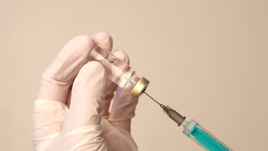 Syringe with a medicine in a hand 