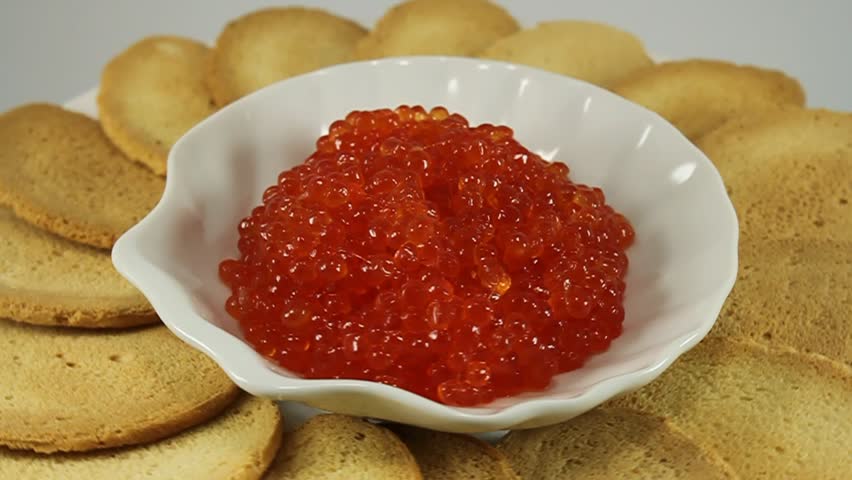 red salmon roe in a ceramic bowl and toast 