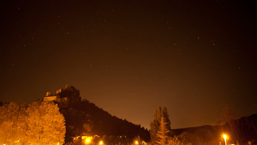 time-lapse of a a castle on hill with stars, clouds and fog,  night-scape 