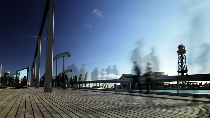 time-lapse of people on a boardwalk 