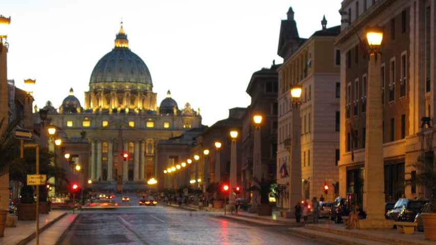 People and vehicles passing on Via della Conciliazione in time lapse at night