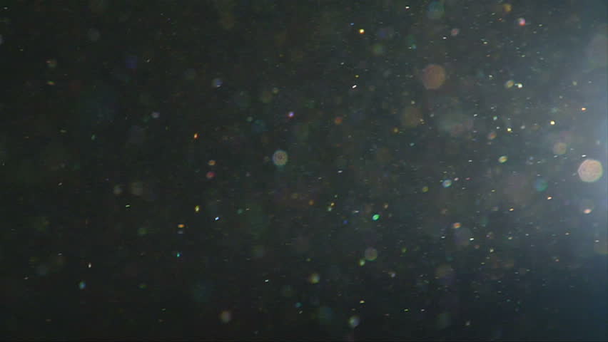 This is a close up shot of dust particles dancing in the flickering light of a 16mm projector.  Shot at 60fps for a pulsing slow motion effect.