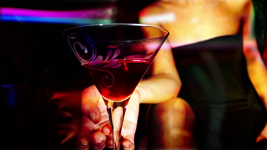 beautiful classic pinup girl in a VIP club drinking a cocktail