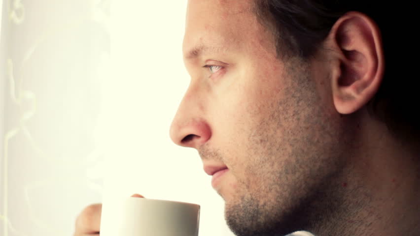 Young handsome man drinking coffee