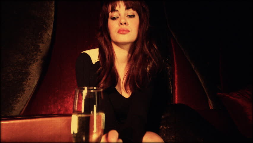 beautiful classic pinup girl in a VIP club drinking champagne