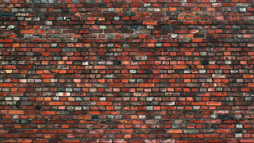 Graffiti sprays on to brick wall.