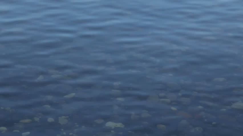 Rocks can be seen through the rippling clear water of this Minnesota lake.